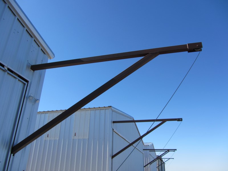 Exterior of airplane hangar door using custom sheave pulley block