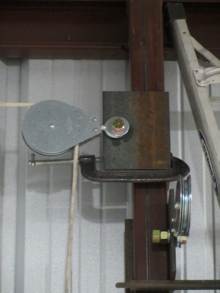 Fixed eye pulley block used in heavy duty commercial garage door system